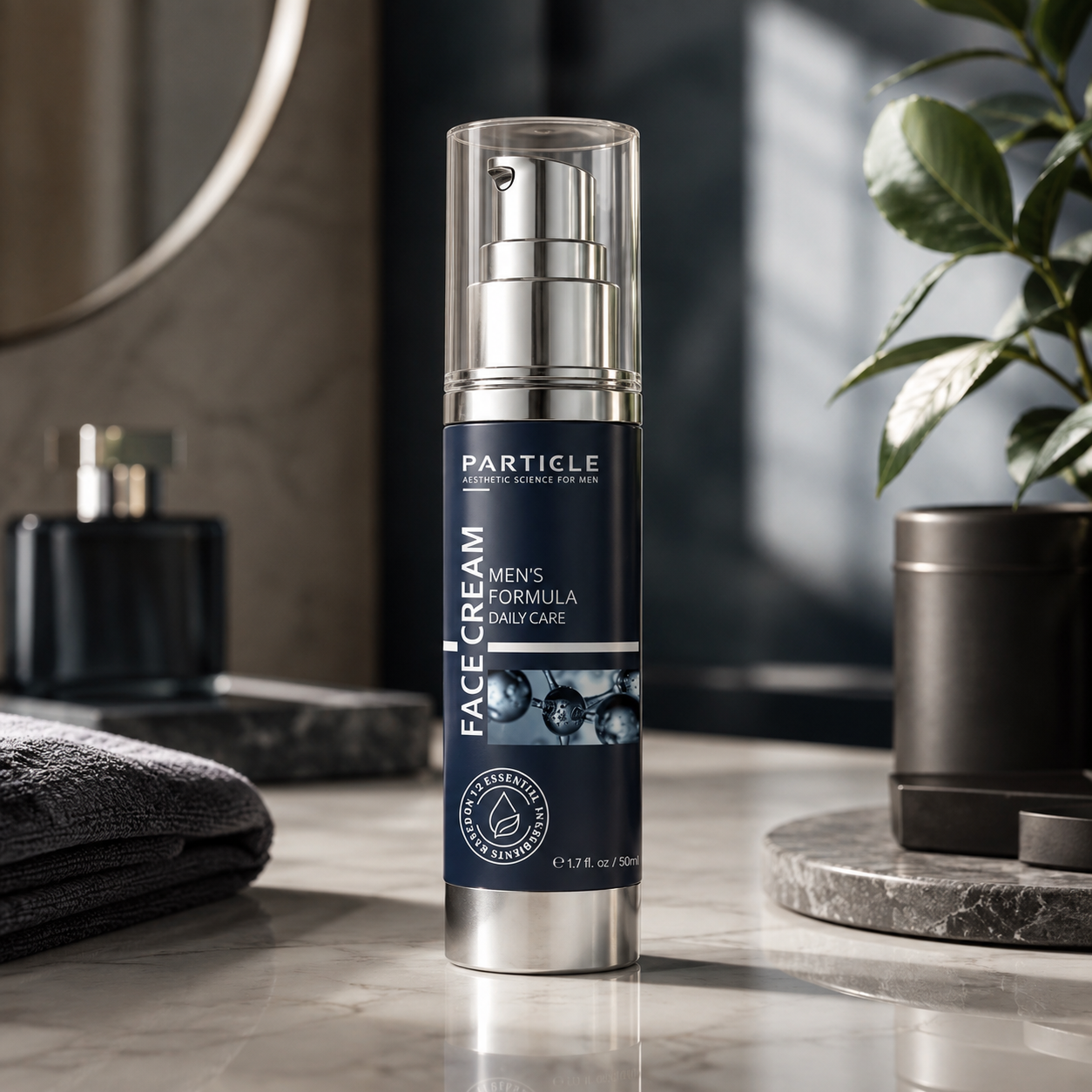 Particle London Men's Face Cream in a sleek silver and navy blue pump bottle, set on a marble bathroom counter with a folded towel, plant, and other toiletries in the background.